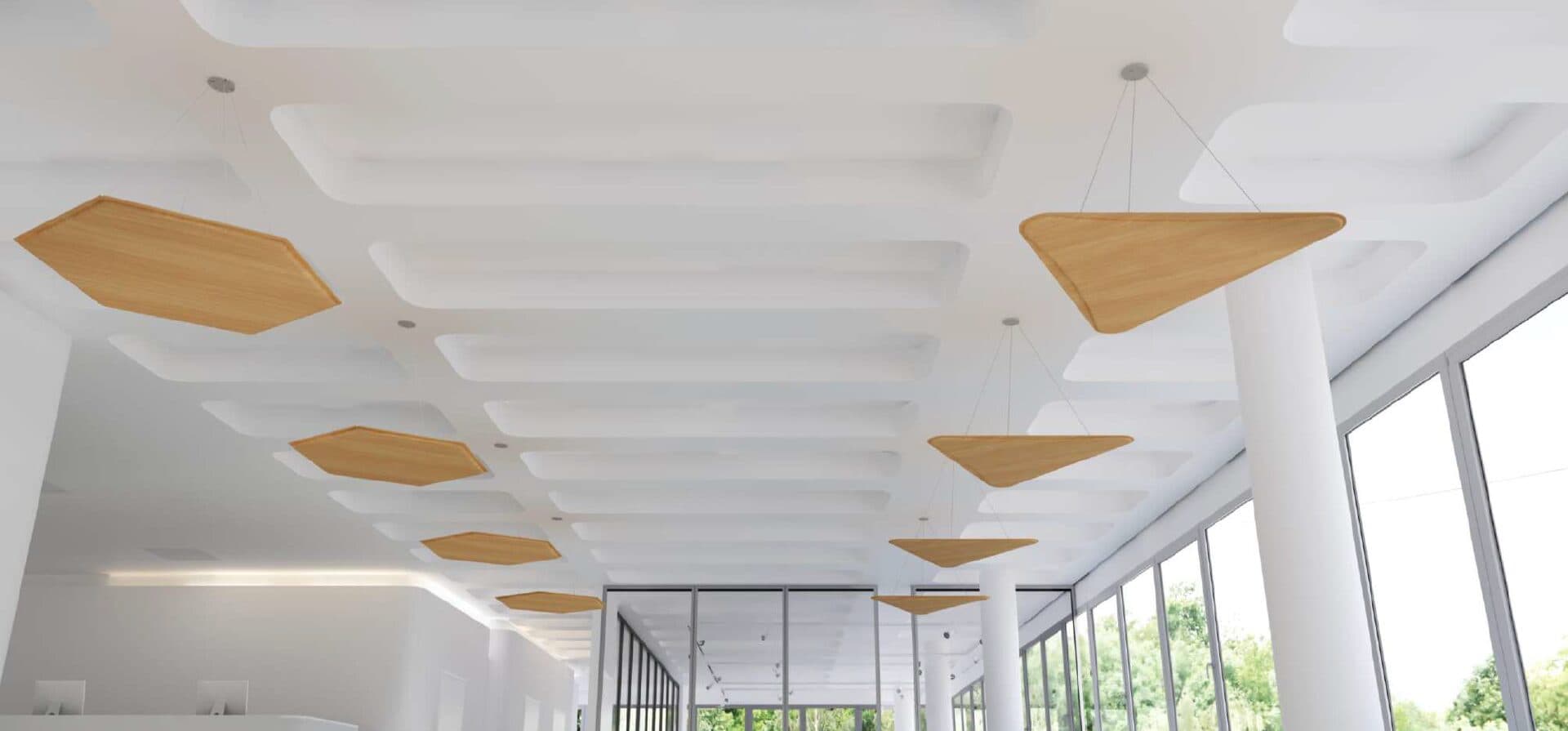 Daylit hall with timber triangular acoustic clouds suspended below a white coffered ceiling