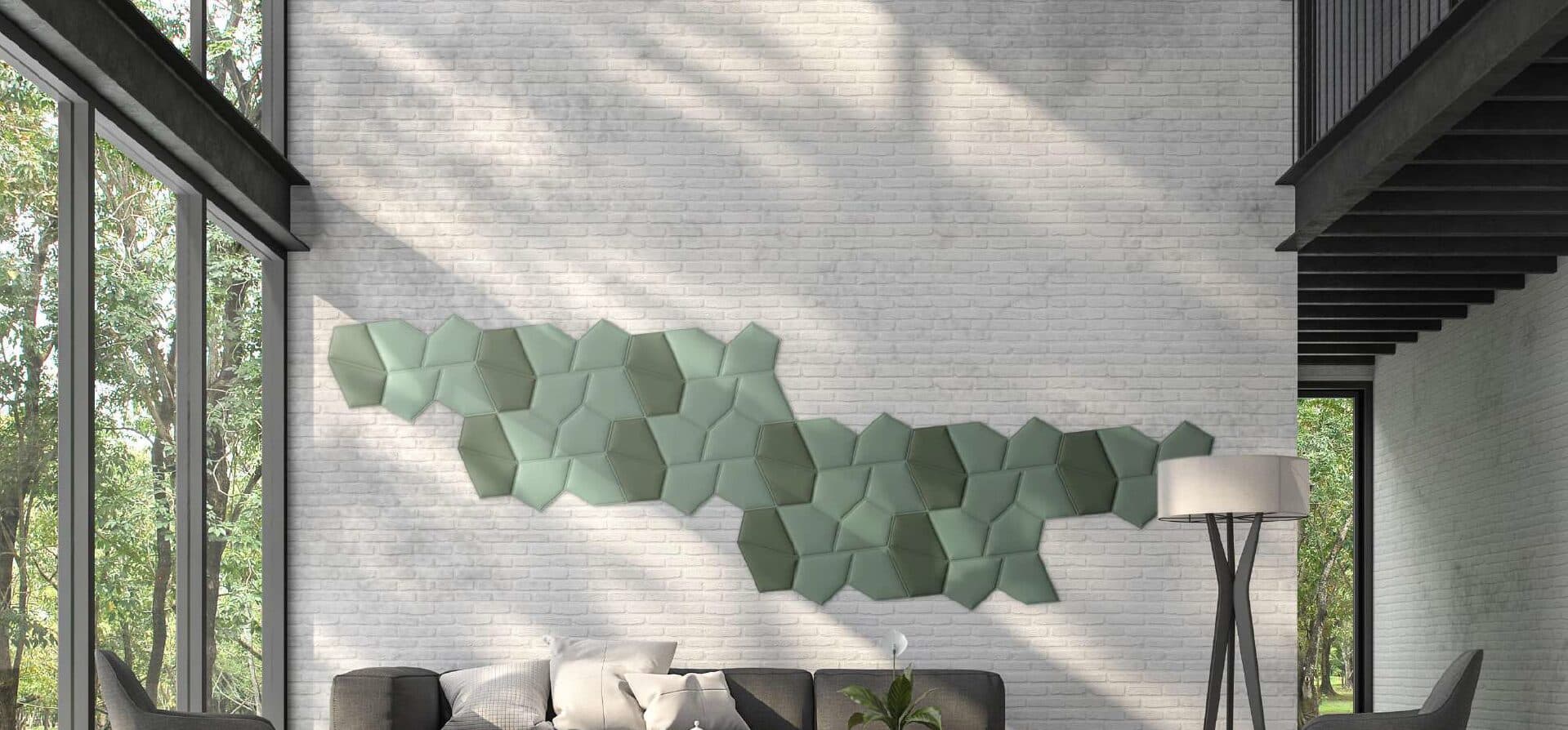 Daylit brick lounge with a drift of sage green faceted acoustic tiles across the wall